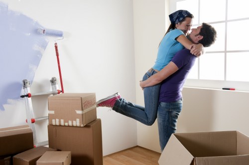 Packed moving boxes and furniture in a Brompton flat