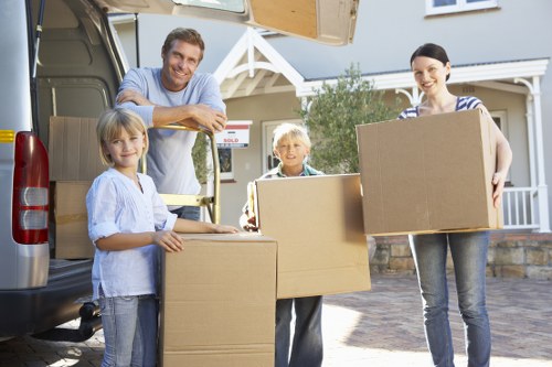 Professional movers handling furniture for a Brompton flat relocation