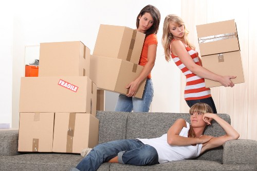 Local moving team handling boxes for a Brompton flat move