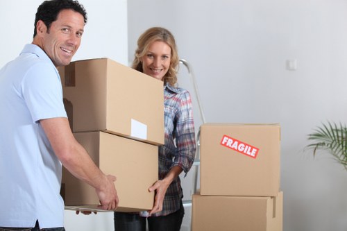 Moving staff handling packed boxes carefully during a removal